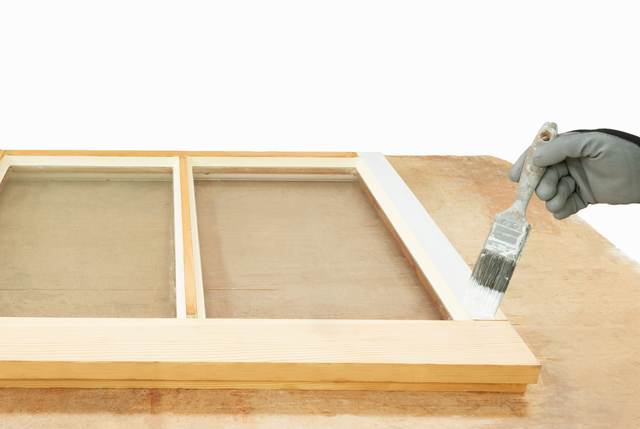 Priming the timber of a repaired sash window frame